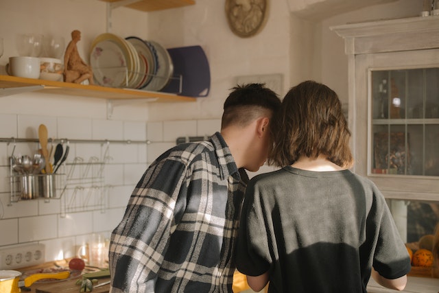 two tenants making food in their kitchen